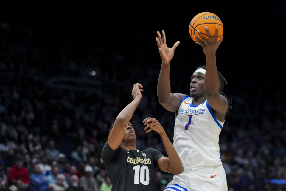 Boise State forward O'Mar Stanley, right, drives to the basket against Colorado forward Cody Williams during the first half of a First Four game in the NCAA men's college basketball tournament Wednesday, March 20, 2024, in Dayton, Ohio. (AP Photo/Aaron Doster)