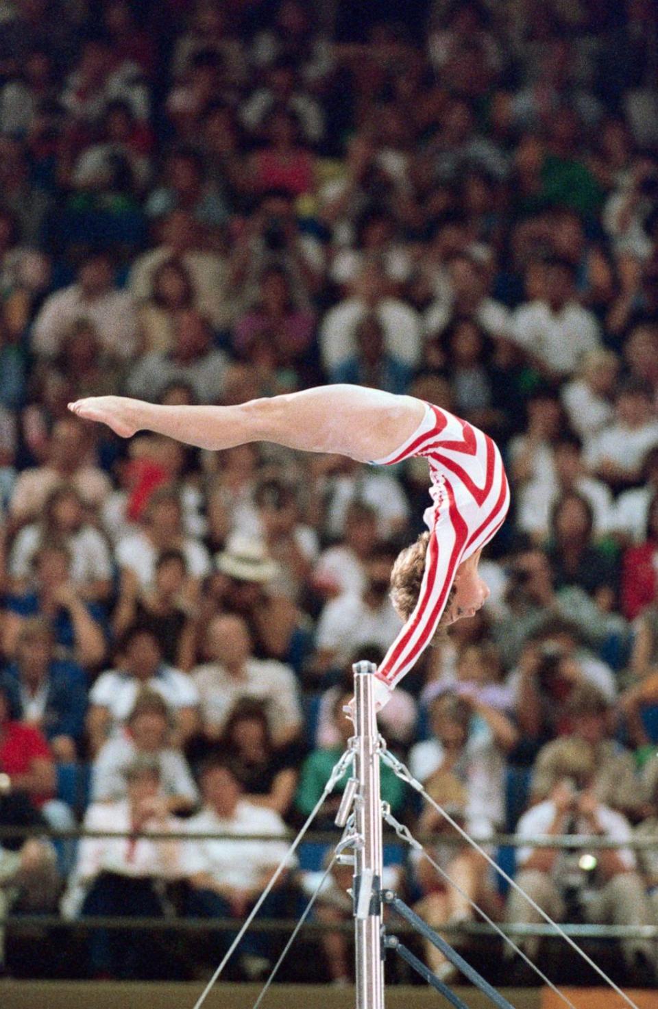 PHOTO: Mary Lou Retton performing on the uneven bars in Los Angeles on Aug. 1, 1984. (Bettmann Archive via Getty Images, FILE)