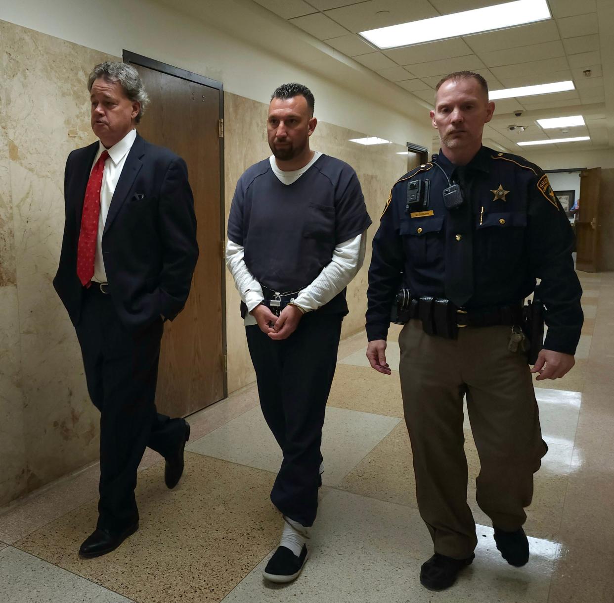 Brett Garza walks out of the courtroom with his attorney, Ted Hogan, left, after he entered an open plea to murder in the 2019 slaying of 79-yera-old Celestino Rodriguez. He is set to appear May 13 in the 137th District Court for a sentencing bench trial.