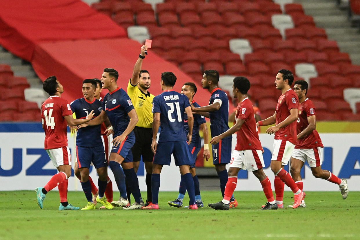 Singapore's Safuwan Baharudin (No.21) is shown the red card by referee Qasim Matar Ali Al-Hatmi during the AFF Suzuki Cup semi final second leg against Indonesia.