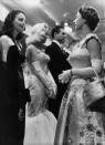 <p>When Queen Elizabeth chatted with screen star Ava Gardner at the premiere of <em>To Catch a Thief, </em>the actress looked impossibly chic in a black evening gown and matching gloves. </p>