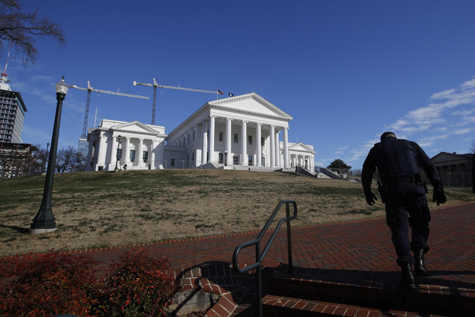 Police patrol around Capitol Square for the anticipated pro gun rally at the Virginia State Capitol Sunday, Jan. 19, 2020, in Richmond, Va. (AP Photo/Steve Helber)