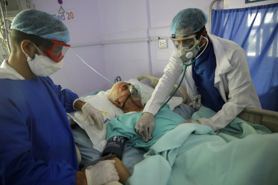 Medical workers attend to a COVID-19 patient in an intensive care unit at a hospital in Sanaa, Yemen, on June 14, 2020. (Photo: Hani Mohammed/AP)