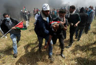 <p>A wounded Palestinian demonstrator is evacuated during clashes with Israeli troops at the Israel-Gaza border at a protest demanding the right to return to their homeland, in the southern Gaza Strip, April 6, 2018. (Photo: Ibraheem Abu Mustafa/Reuters) </p>