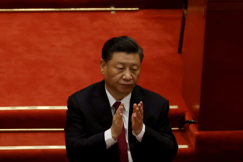 FILE PHOTO: Chinese President Xi Jinping applauds at the opening session of the National People's Congress (NPC) at the Great Hall of the People in Beijing, China March 5, 2021