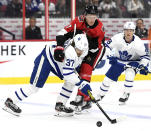 Ottawa Senators left wing Brady Tkachuk (7) becomes entangled with Toronto Maple Leafs defenseman Timothy Liljegren (37) during first-period NHL hockey game action in Ottawa, Ontario, Saturday, Feb. 15, 2020. (Justin Tang/The Canadian Press via AP)