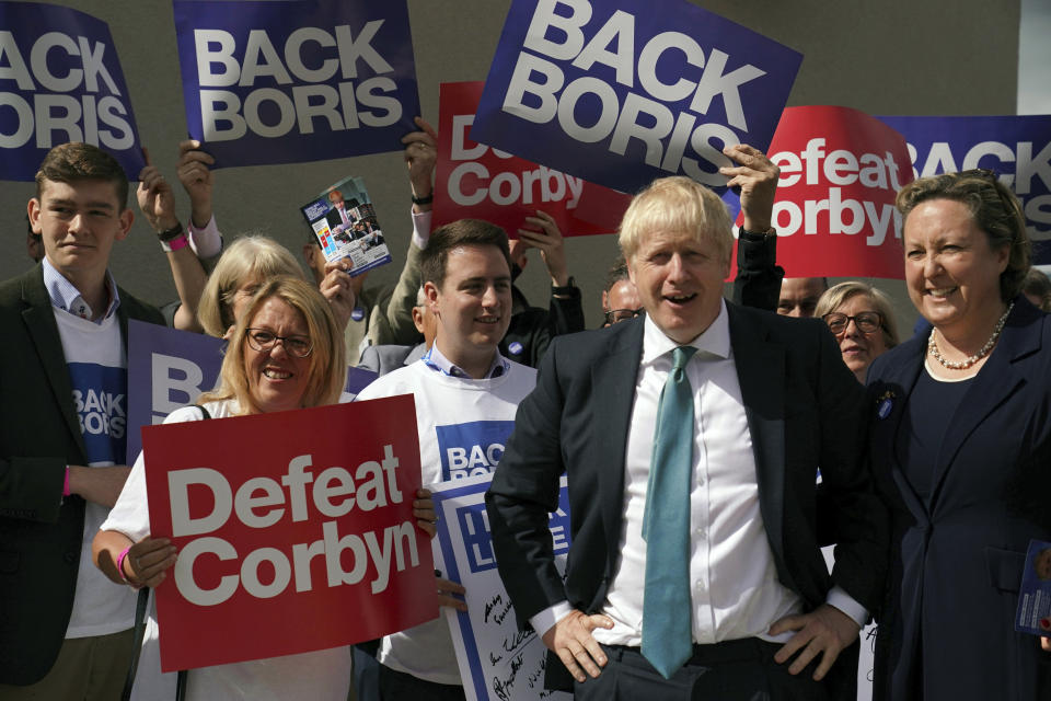 Britain's Conservative Party leadership contender Boris Johnson backed-up by supporters during a party leadership hustings in Darlington, England, Friday July 5, 2019.  The two contenders, Jeremy Hunt and Boris Johnson are competing for votes from party members, with the winner replacing Prime Minister Theresa May as party leader and Prime Minister of Britain's ruling Conservative Party. ( Owen Humphreys/PA via AP)