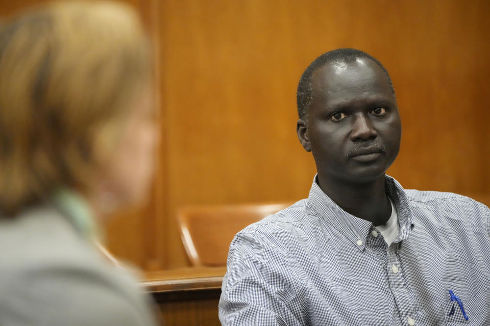 Bul Mabil, brother of Dau Mabil, a 33-year-old Jackson, Miss., resident who went missing on March 25 and whose body was found in April floating in the Pearl River in Lawrence County, stares at his brother's widow, Karissa Bowley, during a recess at a hearing, Tuesday, April 30, 2024 in Jackson, Miss. The hearing is on whether a judge should dissolve or modify his injunction preventing the release of Mabil's remains until an independent autopsy could be conducted. (AP Photo/Rogelio V. Solis)