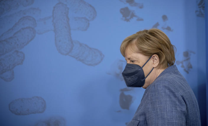 German Chancellor Angela Merkel leaves a press conference following her visit to the Robert Koch Institute (RKI) in Berlin, Germany, Tuesday, July 13, 2021. Merkel visited the health ministry's leading institute in the Corona pandemic at the invitation of Health Minister Spahn. (Michael Kappeler/Pool via AP)