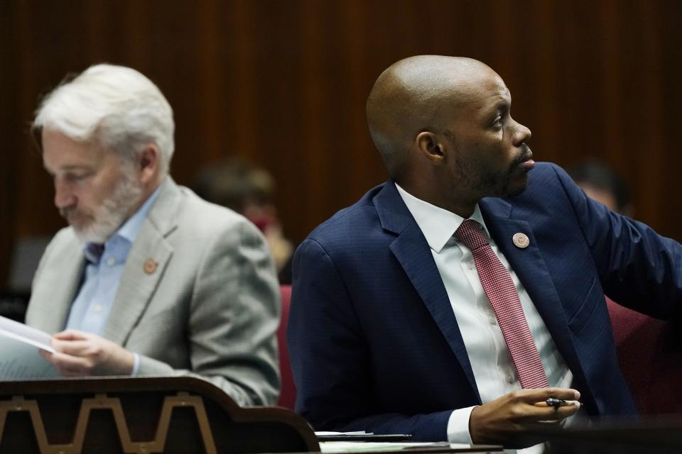 House Minority Leader Reginald Bolding, D-Laveen, right, pauses on the Arizona House floor along with Rep. Randall Friese, D- Tucson, left, during a vote on part of the Arizona budget, SB1828 on taxation, at the Arizona Capitol Thursday, June 24, 2021, in Phoenix. (AP Photo/Ross D. Franklin)