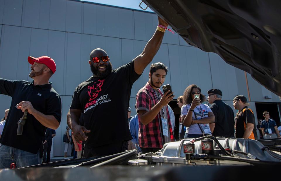 Herman Young, 57, shows off his car's engine during the Roadkill Nights 2022 preview event at the M1 Concourse in Pontiac on Aug. 12, 2022.