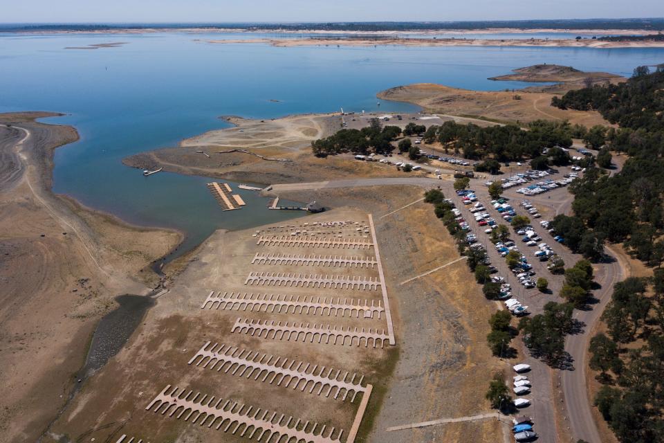 An aerial image shows boats stored in a parking lot after the Folsom Lake Marina closed due to dry lake bed conditions during the California drought emergency on May 27, 2021 in El Dorado Hills, California. A plane wreckage found at the bottom of the lake could solve a decades-old mystery.  (AFP via Getty Images)