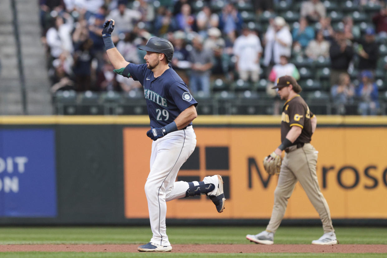 Seattle Mariners' Cal Raleigh, left, runs the bases after hitting a home run off San Diego Padres starting pitcher Yu Darvish as second baseman Jake Cronenworth, right, looks on during the first inning of a baseball game, Tuesday, Sept. 10, 2024, in Seattle. (AP Photo/Jason Redmond)