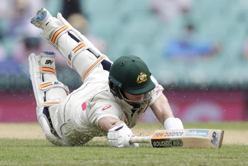 Australia's Steve Smith dives to make his ground but is run out for 131 runs during play on day two of the third cricket test between India and Australia at the Sydney Cricket Ground, Sydney, Australia, Friday, Jan. 8, 2021. (AP Photo/Rick Rycroft)