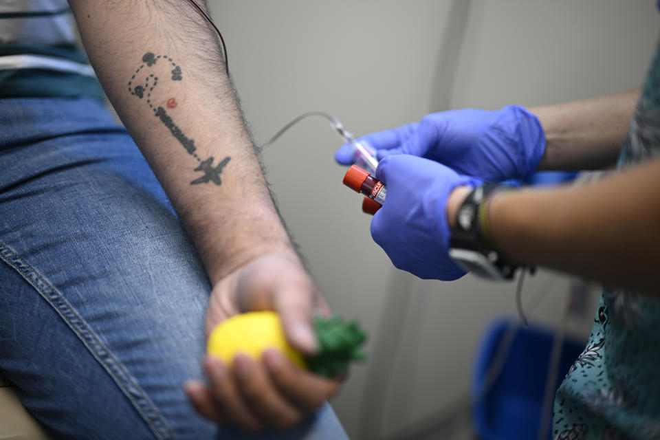 Fernando Hermida has blood drawn for testing at Pineapple Healthcare in Orlando, Fla., on May 28, 2024. (AP Photo/Phelan M. Ebenhack)