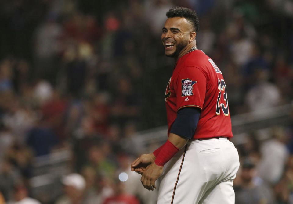 FILE - In this Sept. 19, 2019, file photo, Minnesota Twins' Nelson Cruz smiles after the Twins defeated the Kansas City Royals 8-5 in a baseball game in Minneapolis. Cruz had five RBIs, including two home runs. Cruz received the Muhammad Ali Sports Humanitarian Award at the ESPY Awards on Sunday, June 21, in a videotaped piece introduced by the late boxer's daughter, Laila. Cruz has helped his hometown of Las Matas de Santa Cruz in the Dominican Republic build a police station, a medical clinic and acquire a fire truck and firefighting gear as well as an ambulance. (AP Photo/Jim Mone, File)