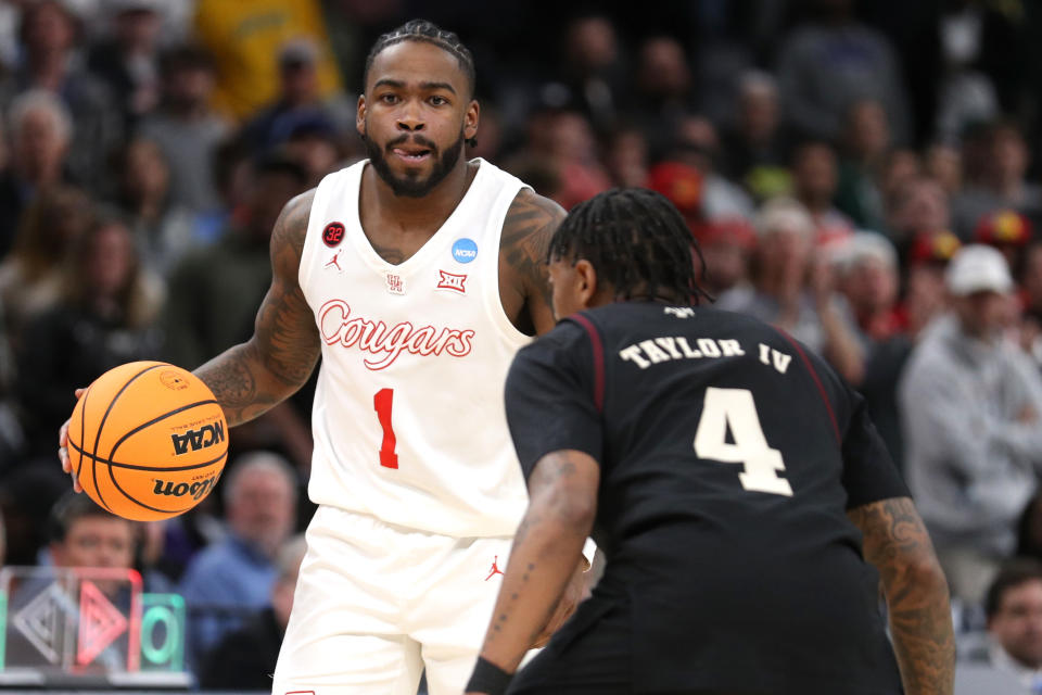 MEMPHIS, TENNESSEE - MARCH 24: Jamal Shead #1 of the Houston Cougars dribbles the ball over Wade Taylor IV #4 of the Texas A&M Aggies during overtime in the second round of the NCAA Men's Basketball Tournament at FedExForum on March 24, 2024 in Memphis, Tennessee. (Photo by Justin Ford/Getty Images)