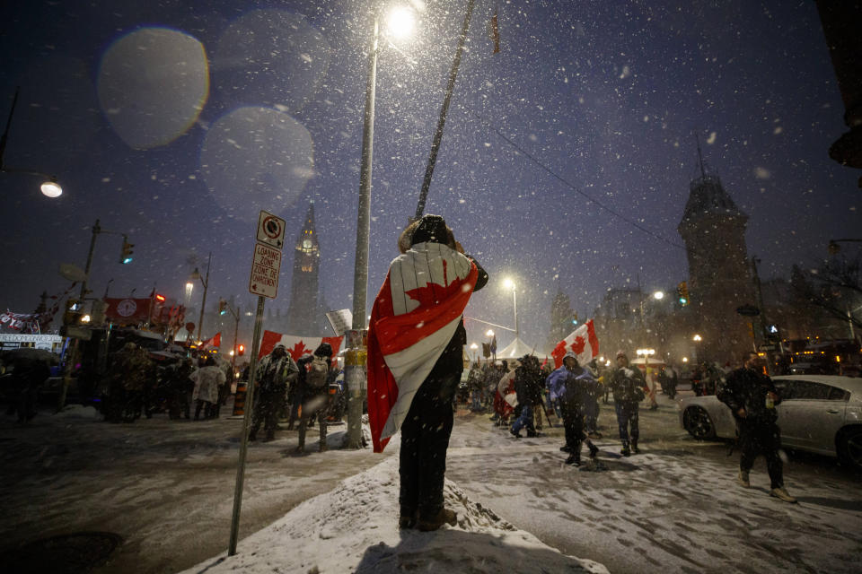 Protesters and supporters gather during a protest against COVID-19 measures that has grown into a broader anti-government protest that continues to occupy downtown Ottawa, Ontario, on Thursday, Feb. 17, 2022. (Cole Burston/The Canadian Press via AP)