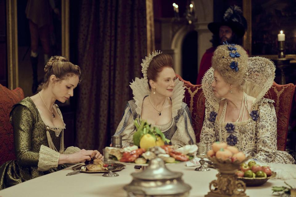 a group of women sitting at a table with food