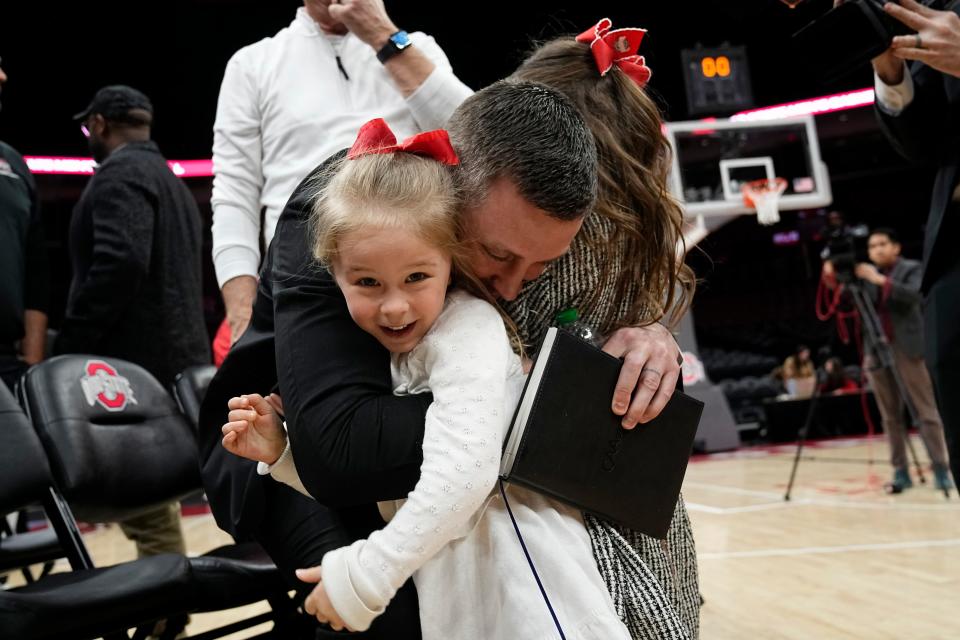 Mar 18, 2024; Columbus, OH, USA; Ohio State basketball head coach Jake Diebler hugs his daughters, Jessa and Jaymes, during his introductory press conference at Value City Arena.