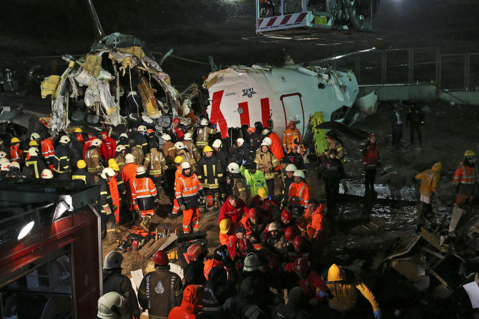 Rescue members evacuate an injured person from the wreckage of a plane after it skidded off the runway at Istanbul's Sabiha Gokcen Airport, in Istanbul, Wednesday, Feb. 5, 2020. The plane skidded off as it tried to land in bad weather, crashing into a field and breaking into pieces. Passengers had to evacuate through cracks in the smashed plane and authorities said 120 people were sent to the hospital with injuries. (AP Photo/Emrah Gurel)