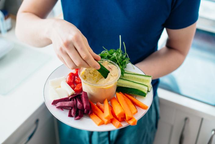 A tray of vegetables and hummus