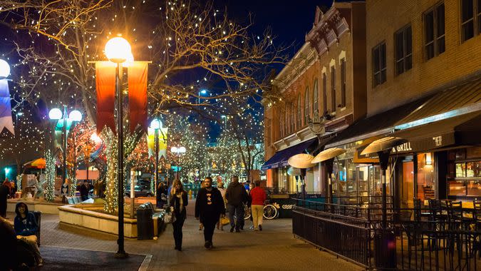 Fort Collins, Colorado, USA - February 2, 2013: People walking in the Old Town pedestrian zone of Fort Collins, Colorado at night.