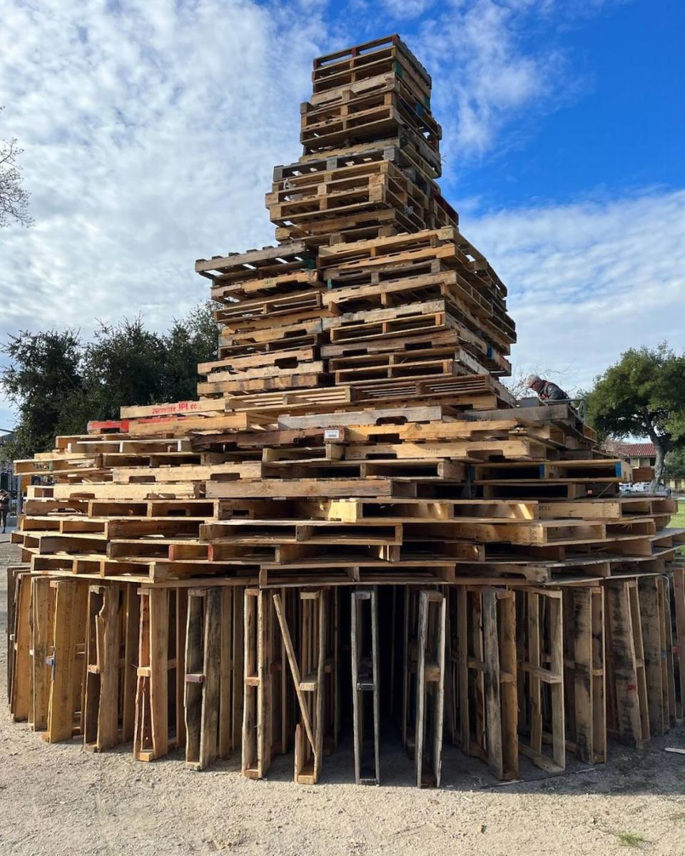 The city of Paso Robles has stacked dozens of wood pallets more than 20 feet high in the Downtown City Park for a bonfire and party on New Year’s Eve.