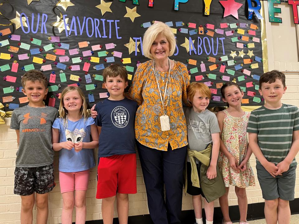 Retiring Bearden Elementary principal Susan Dunlap, center, is shown with some first graders on May 9, 2023, in front of a hall bulletin board with notes from students thanking her for her years of service. Also pictured, from left, are Charles Carini, Liv Bailey, Mickey Bernier, Rhett Kunz, Lucy Ashe and Justus Kerr. These children said they like Dunlap because she is nice, cheers people up and loves UT sports.