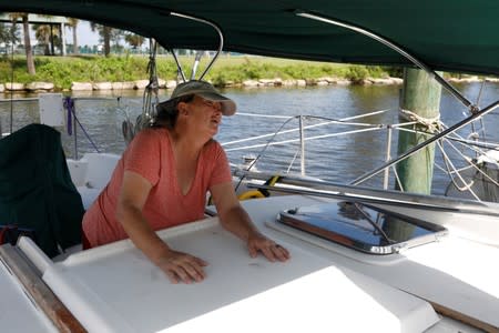 Lisa Keahey, who lives in a sailboat with her husband Ned and plans to stay aboard during Hurricane Dorian, is seen in her sailboat at a marina in Titusville