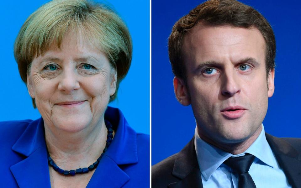 Angela Merkel froze Emmanuel Macron out of EU negotiations with Greece after he called the debt deal a 'modern-day version of the Versailles Treaty,' a new book claims.  - AFP