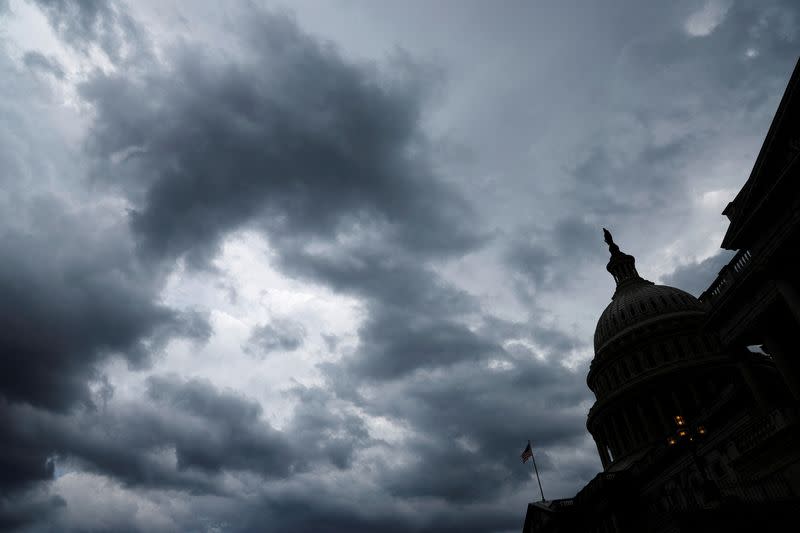 FILE PHOTO: Storm clouds pass over the U.S. Capitol in Washington