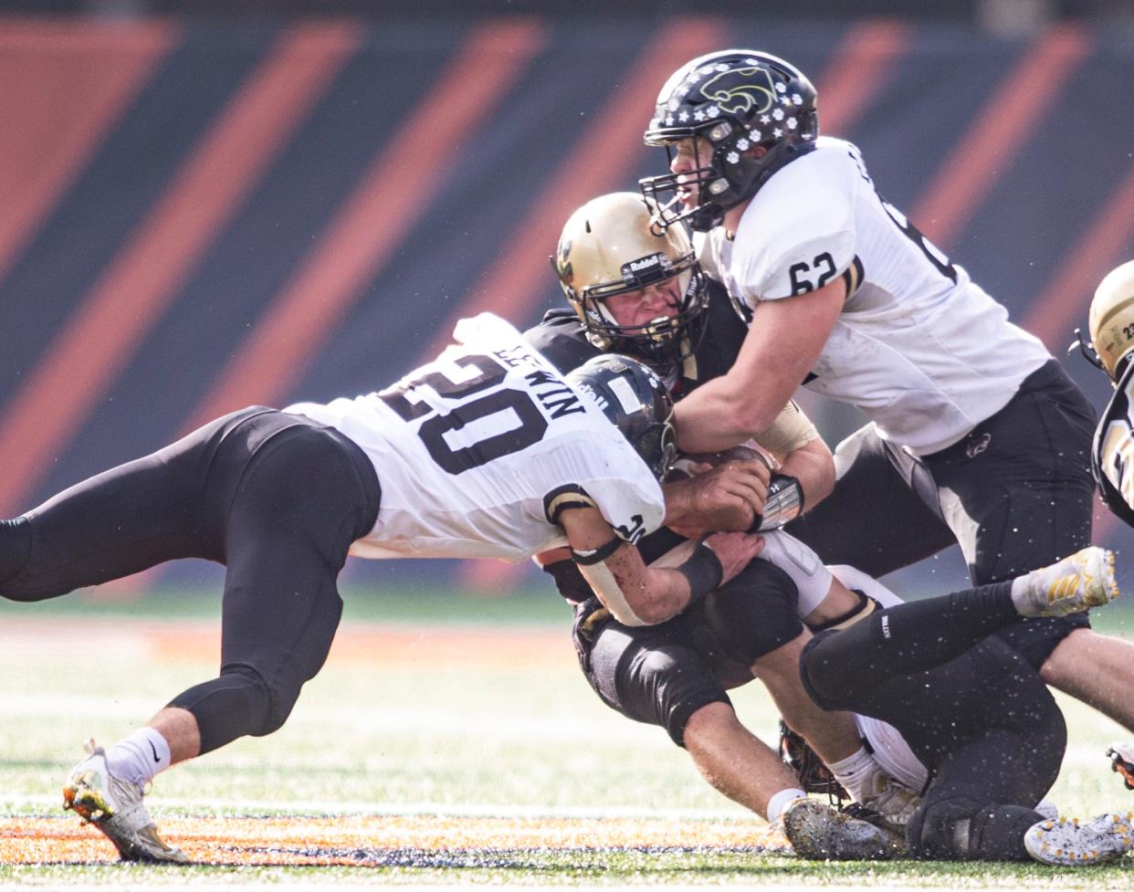 Lena-Winslow's Gunar Lobdell and Henry Engel make a tackle against Camp Point Central on Friday, Nov. 25, 2022, at University of Illinois in Champaign.