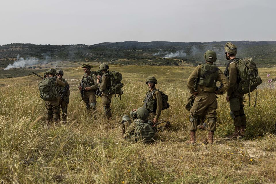 In this Wednesday, May 13, 2020 photo, Israeli troops take part in a drill in northern Israel. Twenty years after Hezbollah guerrillas pushed Israel’s last troops from southern Lebanon, both sides are gearing up for a war that neither seems to want. Israeli troops are drilling for a possible invasion of Lebanon and striking Hezbollah targets in neighboring Syria. Hezbollah is beefing up its own forces and threatening to invade Israel. (AP Photo/Tsafrir Abayov)