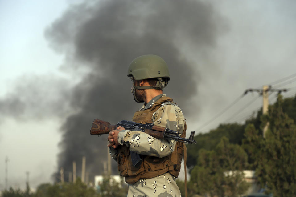 ADDS DATE - Smoke rises as angry Kabul residents set fire to part of the Green Village compound that has been attacked frequently, a day after a Taliban suicide attack in Kabul, Tuesday, Sept. 3, 2019. An interior ministry spokesman said some hundreds of foreigners were rescued after the attack targeted the compound, which houses several international organizations and guesthouses. (AP Photo/Rahmat Gul)