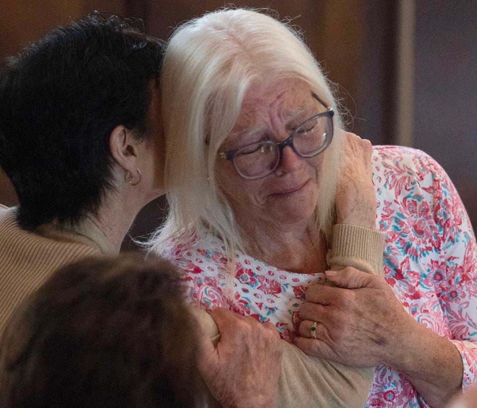 Supporters of Mark Hession embrace after the verdict at Barnstable Superior Courthouse on Friday, where the former Cape Cod priest was found not guilty on two charges of rape.