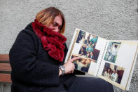 Kobe Bryant's childhood friend Alessia Pierattini cries as she looks at some pictures of Kobe Bryant's first communion, in Cireglio, Italy, January 27, 2020. (REUTERS/Yara Nardi)