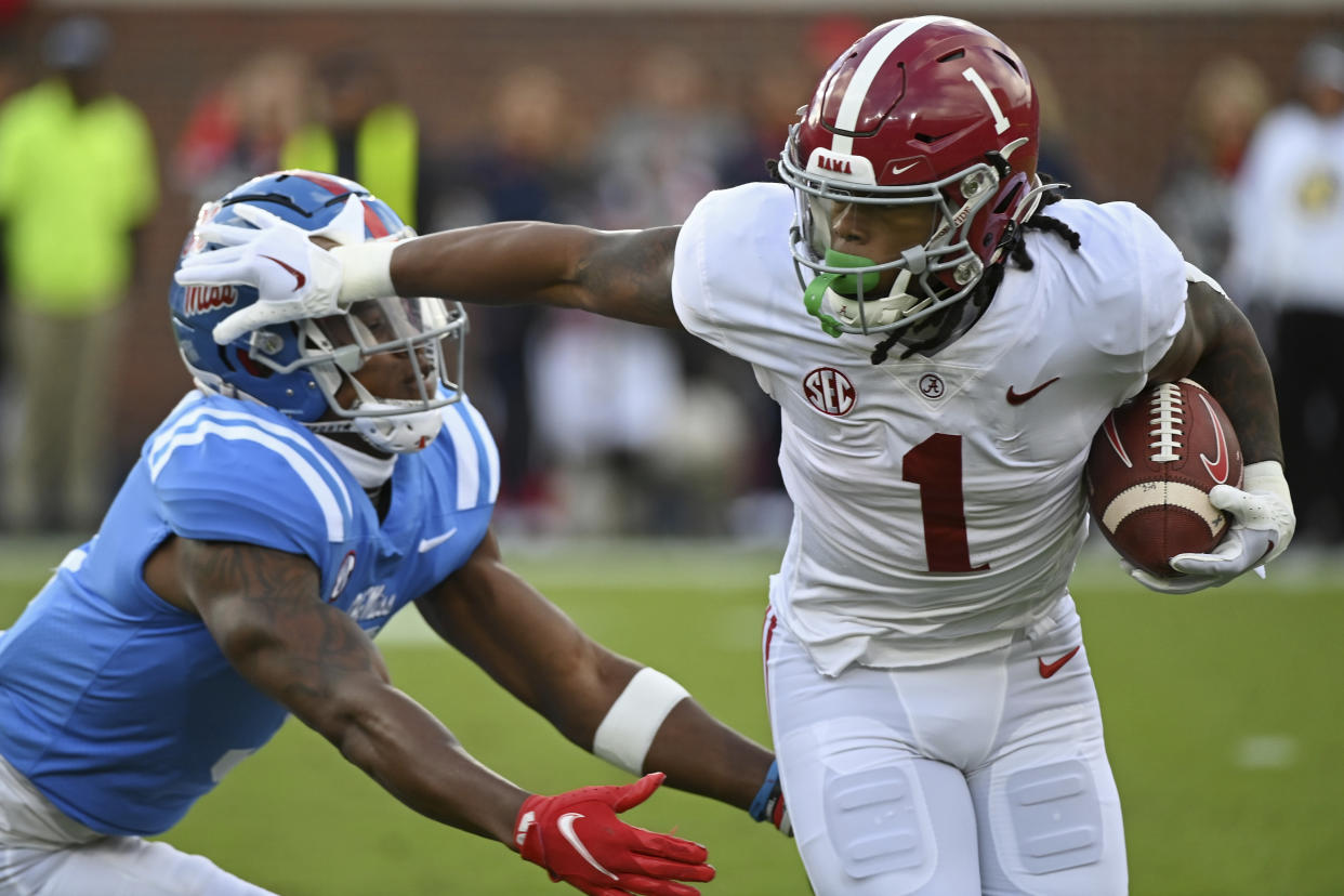 Alabama running back Jahmyr Gibbs (1) fights off Mississippi safety Otis Reese (3) during the first half of an NCAA college football game in Oxford, Miss., Saturday, Nov. 12, 2022. (AP Photo/Thomas Graning)