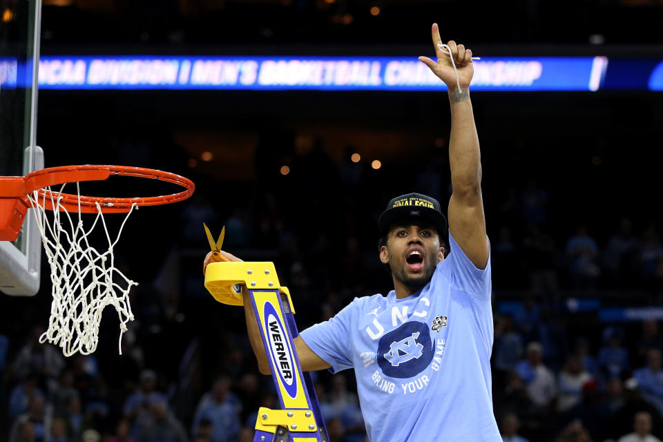 Joel Berry II #2 of the North Carolina Tar Heels celebrates by cutting down the net after defeating the Notre Dame Fighting Irish with a score of 74 to 88 in the 2016 NCAA Men’s Basketball Tournament East Regional Final at Wells Fargo Center on March 27, 2016 in Philadelphia, Pennsylvania. Streeter Lecka/Getty Images