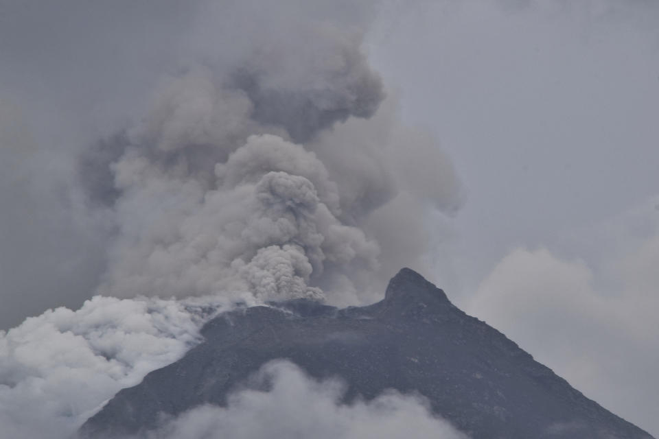 Mount Lewotobi Laki-Laki spews volcanic materials from its crater during an eruption in East Flores, Indonesia, Sunday, Jan. 14, 2024. Thousands of residents in nearby villages have been evacuated from their homes following the increased activity of the more than 2,200-meter (7,200 ft) volcano. (AP Photo/Andre Kriting)