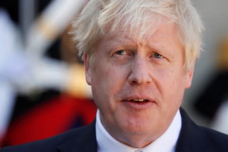 British Prime Minister Boris Johnson delivers a joint statement with French President Emmanuel Macron before a meeting on Brexit at the Elysee Palace in Paris