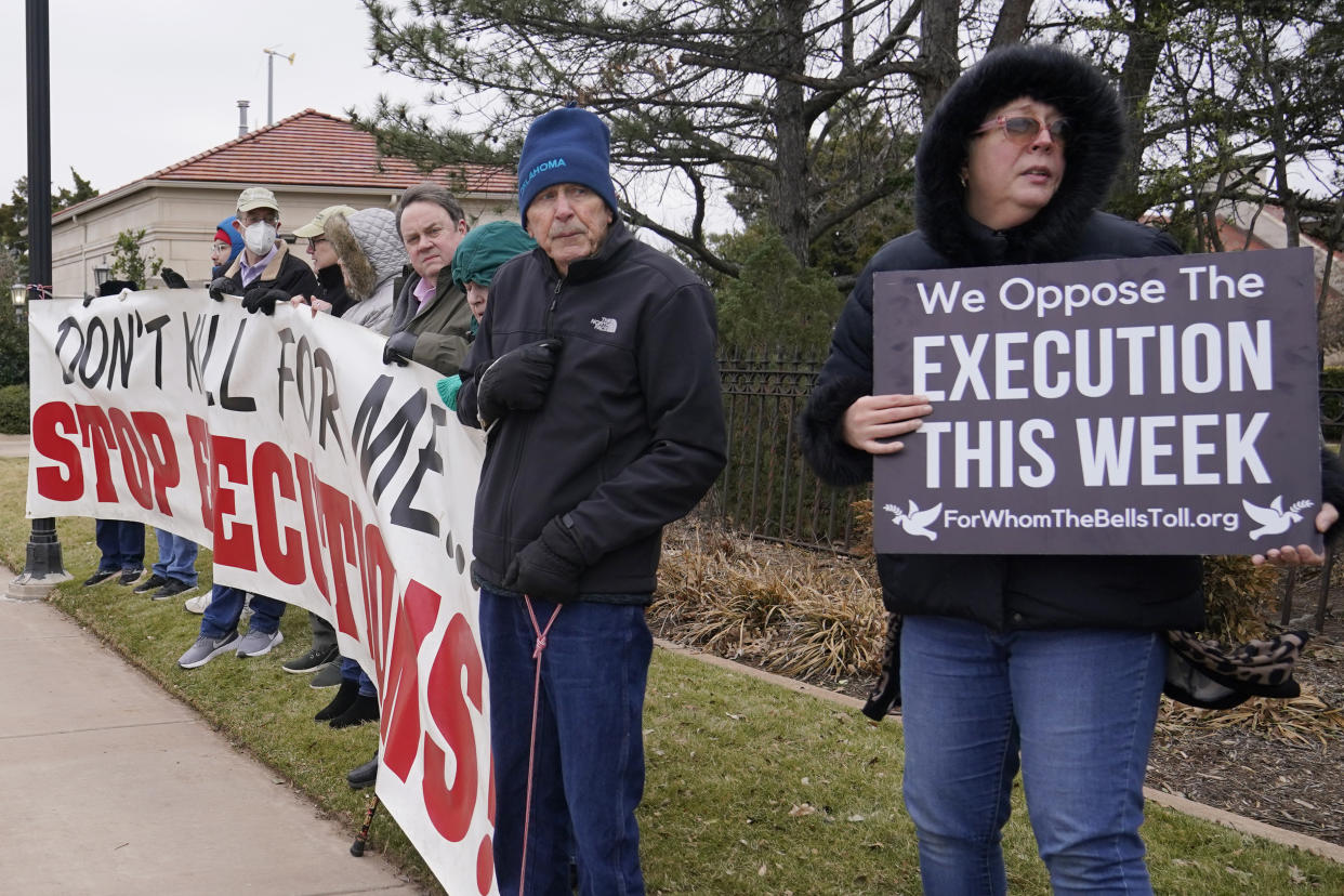 Death penalty opponents protest on the street outside the Governor's mansion, Thursday, Jan. 12, 2023, in Oklahoma City. Oklahoma executed a Scott James Eizember, 62, who was convicted of killing an elderly couple and committing other crimes 20 years ago before authorities caught up to him in Texas after a manhunt. (AP Photo/Sue Ogrocki)