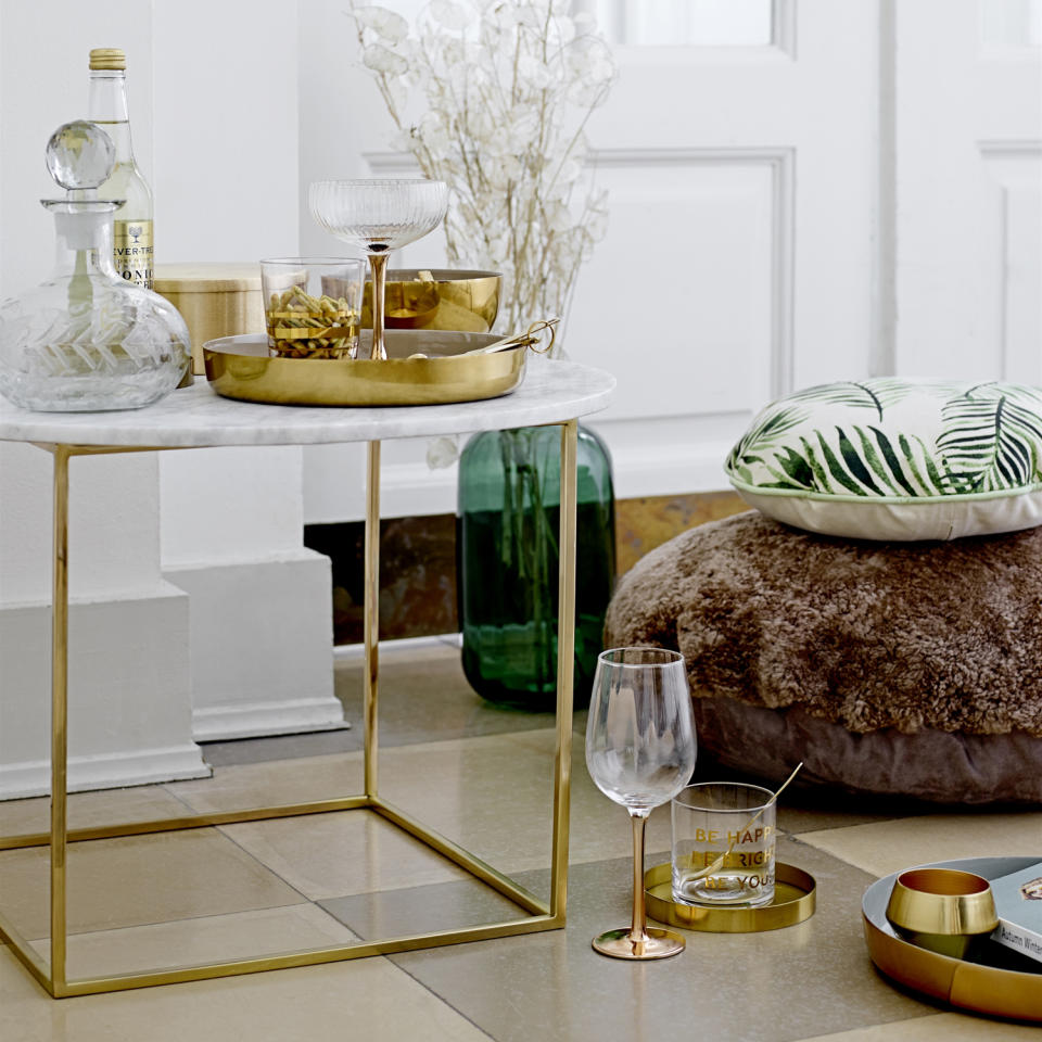 <p> You don&#x2019;t need to use many colors to create an impactful display, here, the common denominator is brass and it works so well. </p> <p> Anything metallic adds style to a scheme and brass is a big trend right now, choose a few key pieces like a round tray, small bowl, vase or use it for storing brass stemmed glassware. Consider your coffee table design too - the brass legs link to the brass accessories - it&#x2019;s a win-win! </p>