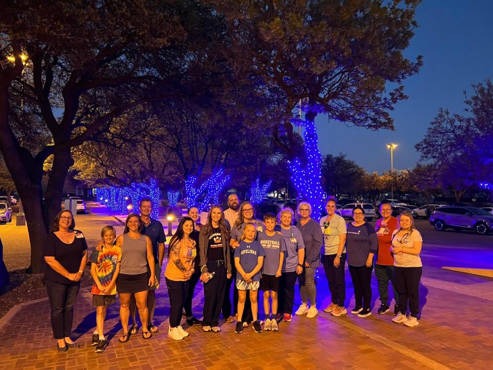 Caregivers at Covenant Children's gathered last week to help light the campus blue to mark Child Abuse Prevention month in April.