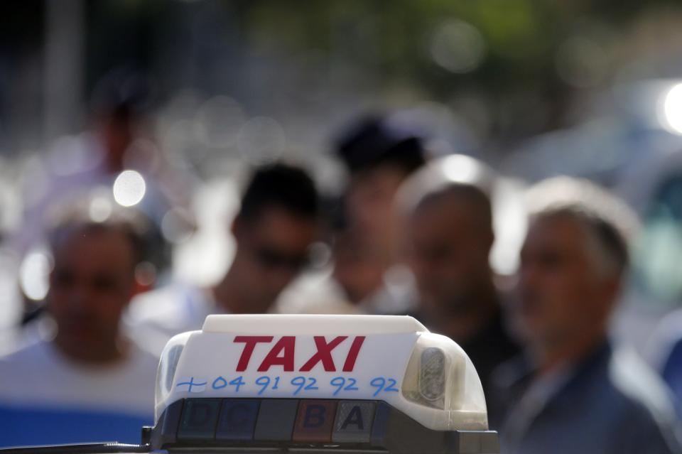 Taxi drivers on strike block the traffic during a national protest against car-sharing service Uber in Marseille, France, June 25, 2015. (REUTERS/Jean-Paul Pelissier)