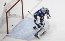 Vancouver Canucks goalie Jacob Markstrom gives up a goal to St. Louis Blues' Brayden Schenn during overtime in Game 3 of an NHL hockey first-round playoff series, Sunday, Aug. 16, 2020, in Edmonton, Alberta. (Jason Franson/The Canadian Press via AP)