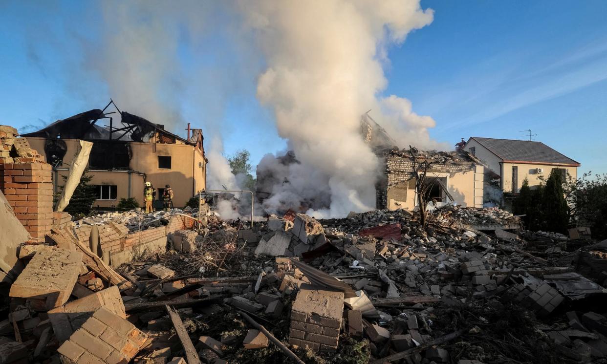 <span>Ukrainian firefighters at the scene of a Russian missile strike in Kharkiv on Friday. </span><span>Photograph: Vyacheslav Madiyevskyy/Reuters</span>