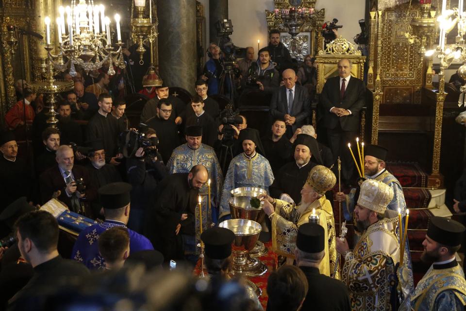 Ecumenical Patriarch Bartholomew I, center right, blesses a priest, center left, as Metropolitan Epiphanius, the head of the independent Ukrainian Orthodox Church, right of him, looks on at the Patriarchal Church of St. George in Istanbul, Sunday, Jan. 6, 2019. An independent Ukrainian Orthodox church has been created at a signing ceremony in Turkey, formalizing a split with the Russian church it had been tied to since 1686. (AP Photo/Lefteris Pitarakis)