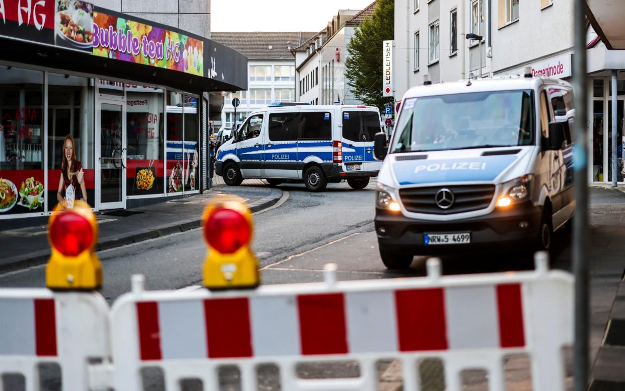 Police cars sit at a cordon early on Saturday in Solingen after the Friday-night attack