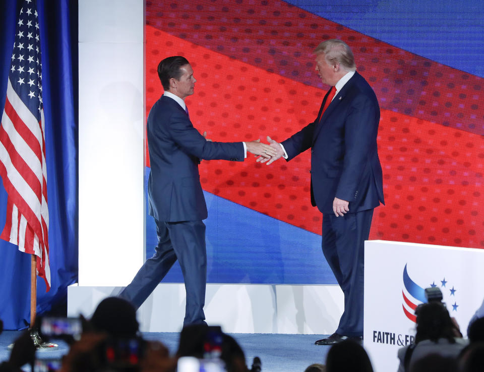 President Donald Trump, right, greets Ralph Reed, left, founder and chairman of the Faith & Freedom Coalition, before speaking at the Faith & Freedom Coalition conference in Washington, Wednesday, June 26, 2019. (AP Photo/Pablo Martinez Monsivais)